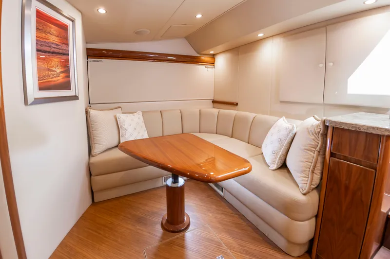 Slide: The Image of Interior of a 2018 Viking Sport Tower with an elegant seating area and wooden table. - 30