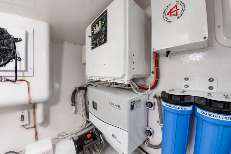 Slide: The Image of A technical room with a water treatment system and electrical controls. - 49