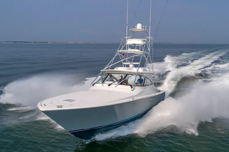 Slide: The Image of A 2018 Viking Sport Tower speeds across the water, with a clear view of the open sea. - 4