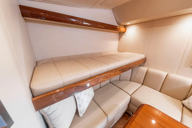 Slide: The Image of Interior of the 2018 Viking Sport Tower with cozy seating and a bunk bed. - 31
