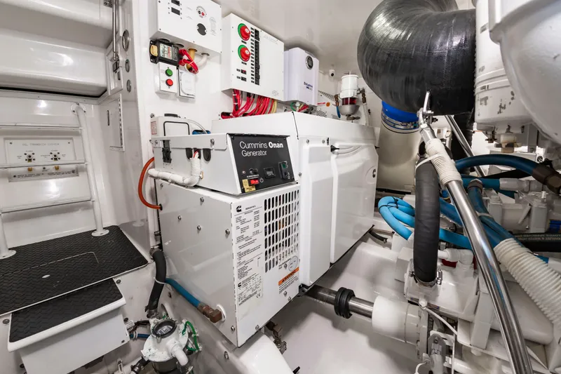 Slide: The Image of The engine room of a 2018 Viking Sport Tower with a Cummins Onan generator and various controls. - 45