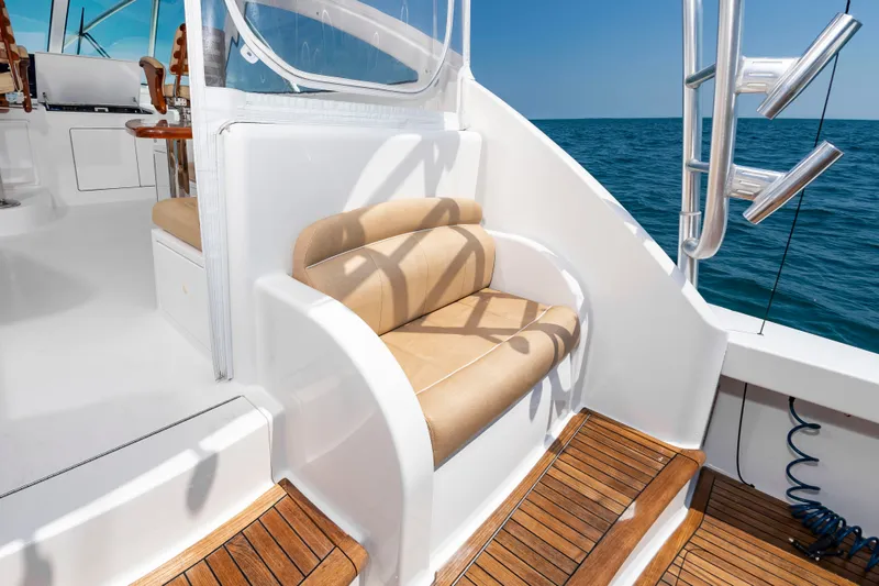 Slide: The Image of A sleek seating area on a 2018 Viking Sport Tower with wooden flooring and ocean view. - 10