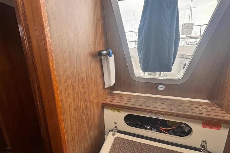 Slide: The Image of Interior view of a 2006 Hunter 31 sailboat, featuring wooden paneling and a hatch. - 35