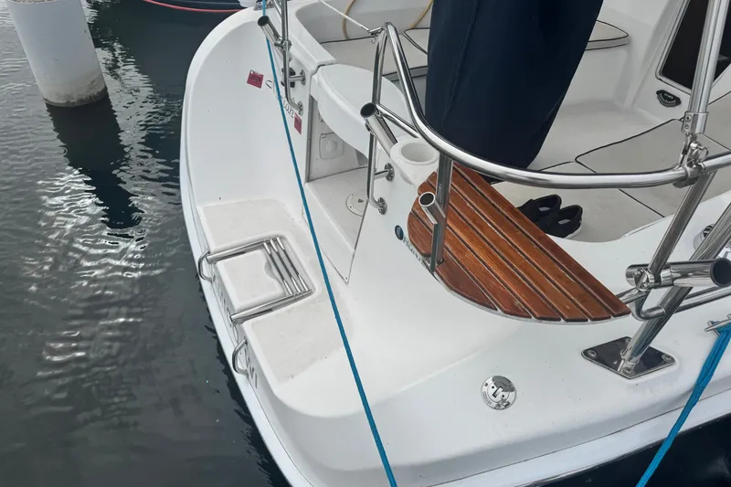 Slide: The Image of Rear deck of a 2006 Hunter 31 sailboat with stainless steel railings and wooden steps. - 15