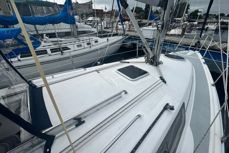Slide: The Image of 2006 Hunter 31 sailboat docked at marina, surrounded by other boats. - 4