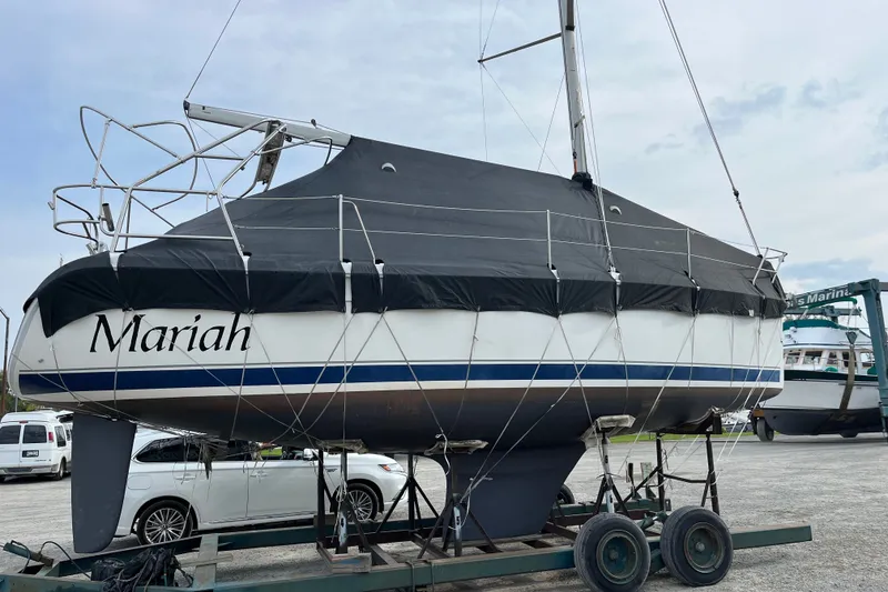 Slide: The Image of 2006 Hunter 31 sailboat named Mariah on trailer, covered and parked in a marina. - 43
