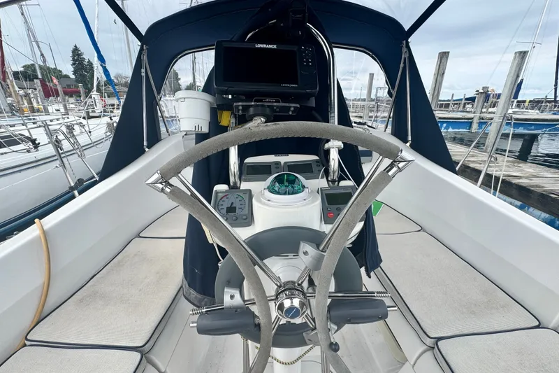 Slide: The Image of Cockpit of a 2006 Hunter 31 sailboat with steering wheel and navigation equipment. - 10