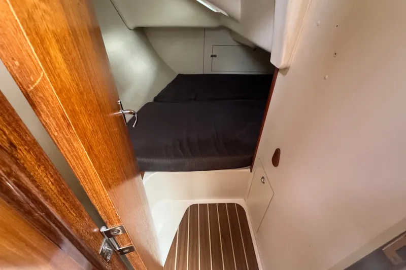 Slide: The Image of Cozy cabin interior of a 2006 Hunter 31 sailboat with wooden door and flooring. - 28