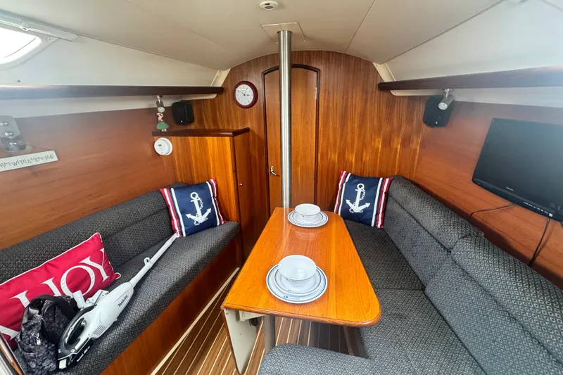 Slide: The Image of Interior of a 2006 Hunter 31 sailboat with cozy seating and nautical decor. - 33
