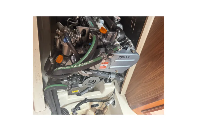 Slide: The Image of Engine compartment of a 2006 Hunter 31 sailboat, showcasing mechanical components and hoses. - 37