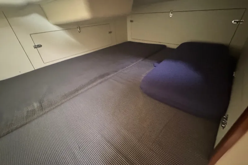 Slide: The Image of Interior cabin of 2006 Hunter 31 sailboat with cushioned sleeping area. - 29