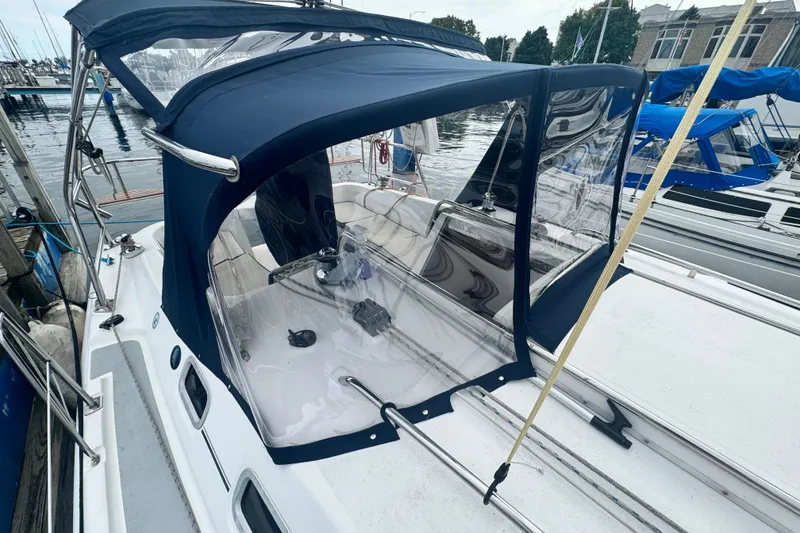 Slide: The Image of 2006 Hunter 31 sailboat with blue canopy docked at marina. - 3