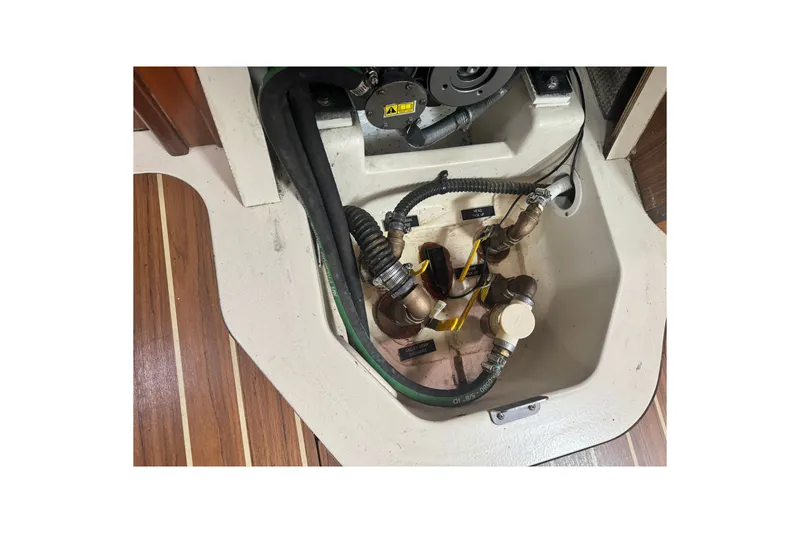 Slide: The Image of Engine compartment of a 2006 Hunter 31 sailboat, showing hoses and fittings. - 36