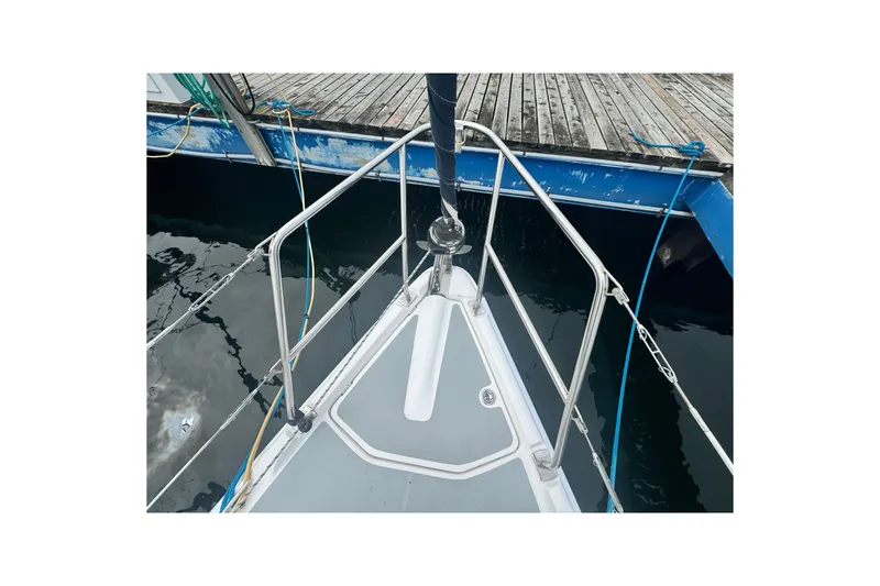 Slide: The Image of Bow of a 2006 Hunter 31 sailboat docked at a marina. - 13