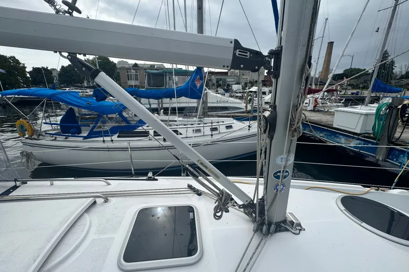 Slide: The Image of 2006 Hunter 31 sailboat docked in a marina with other boats. - 5