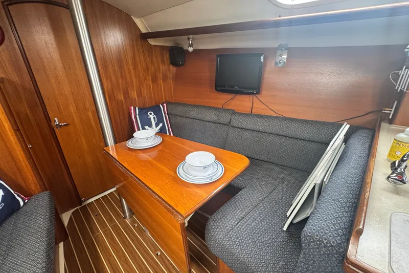 Slide: The Image of Cozy interior of 2006 Hunter 31 sailboat with dining area and TV. - 24