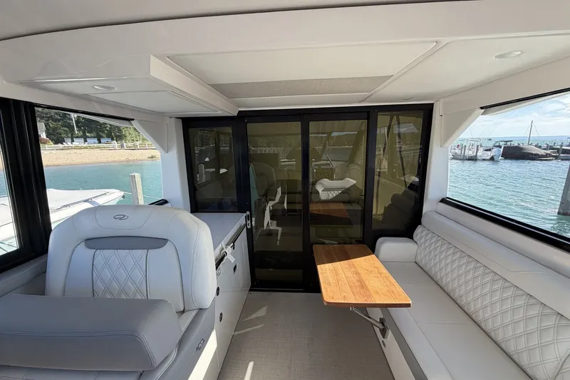 Slide: The Image of Interior of 2022 Regal 36 Grande Coupe yacht with luxurious seating and wooden table. - 21