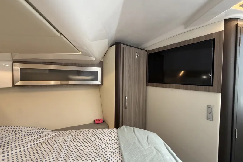 Slide: The Image of Interior cabin of 2022 Regal 36 Grande Coupe with modern design and TV. - 27