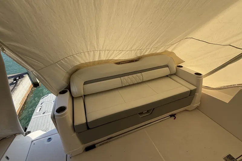 Slide: The Image of Luxury seating on 2022 Regal 36 Grande Coupe yacht under canopy. - 40