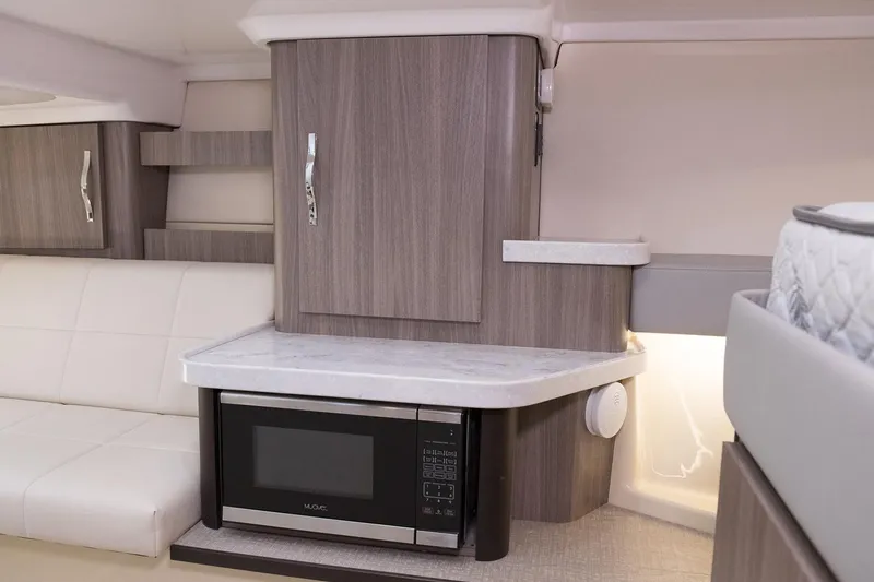 Slide: The Image of Manufacturer Provided Image: 2022 Regal 36 Grande Coupe interior with microwave and modern cabinetry. - 36