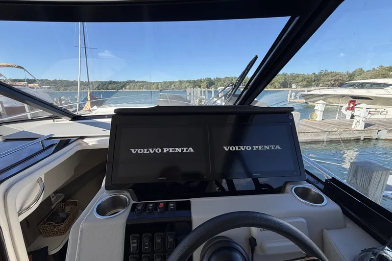 Slide: The Image of 2022 Regal 36 Grande Coupe helm with dual Volvo Penta displays at marina. - 23