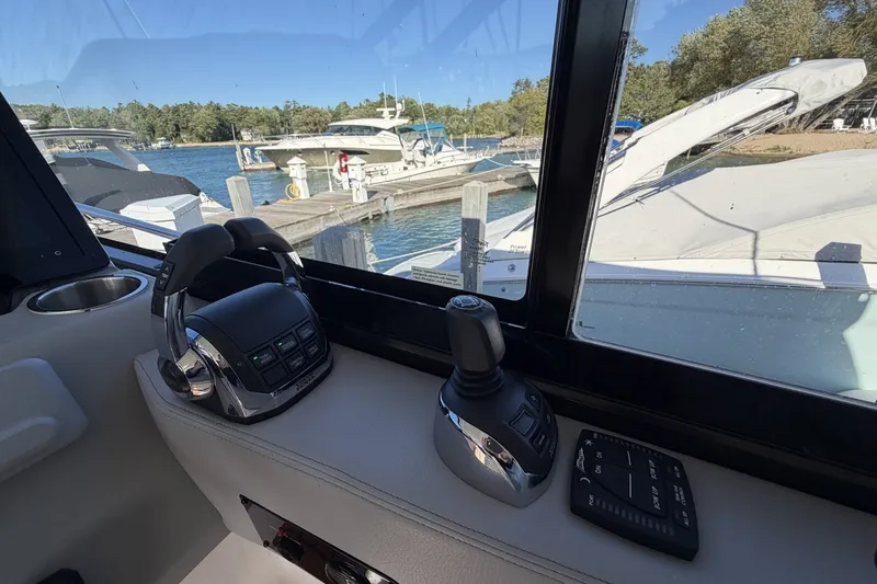 Slide: The Image of Interior view of 2022 Regal 36 Grande Coupe yacht cockpit controls at marina. - 24