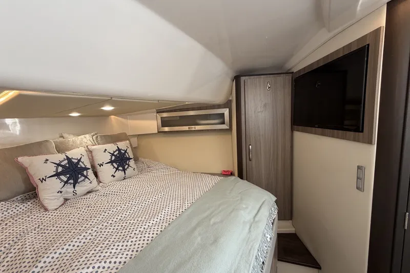 Slide: The Image of Luxurious cabin interior of 2022 Regal 36 Grande Coupe with cozy bedding and nautical decor. - 26