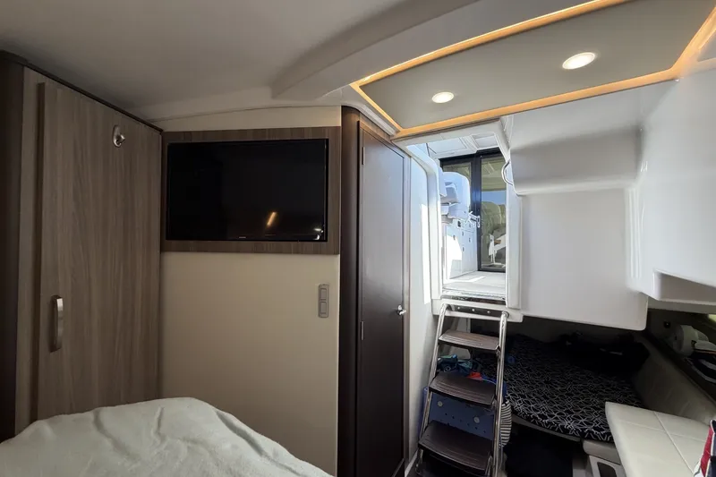 Slide: The Image of Interior of 2022 Regal 36 Grande Coupe with TV, ladder, and modern design elements. - 28