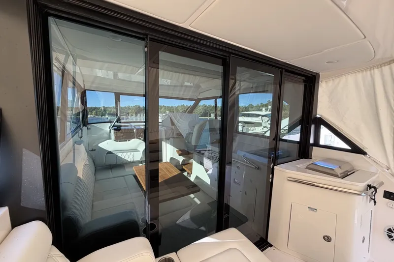 Slide: The Image of Interior view of 2022 Regal 36 Grande Coupe yacht with glass doors and seating area. - 13