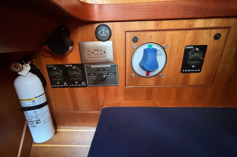 Slide: The Image of Control panel of a 2002 Sabre 402 yacht with switches and fire extinguisher. - 46