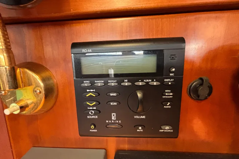 Slide: The Image of Marine audio control panel on a 2002 Sabre 402 yacht, featuring various function buttons. - 45