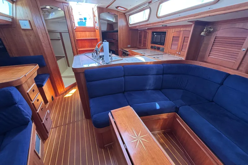 Slide: The Image of Luxurious interior of 2002 Sabre 402 yacht with blue seating and wooden finishes. - 50