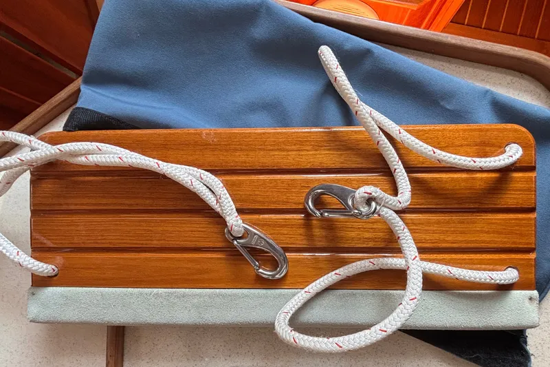Slide: The Image of Wooden panel with ropes and metal clips on a Sabre 402, 2002 model. - 82