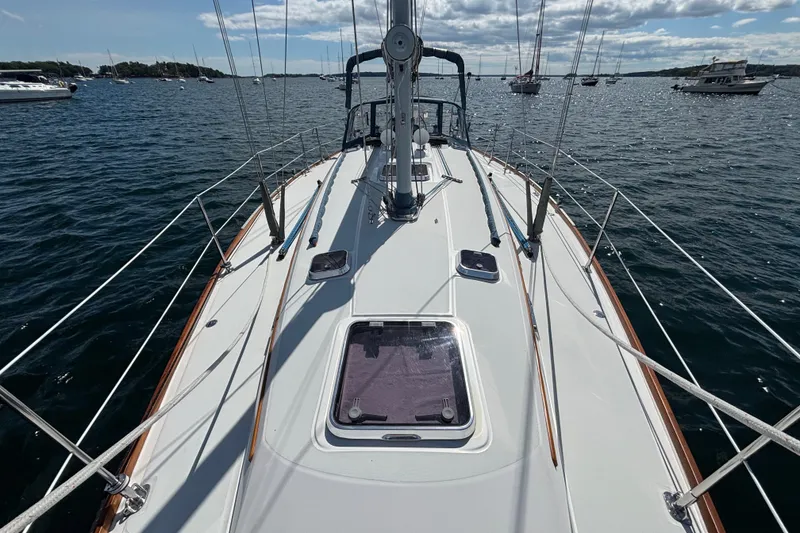 Slide: The Image of 2002 Sabre 402 sailboat deck view on calm water with other boats nearby. - 30