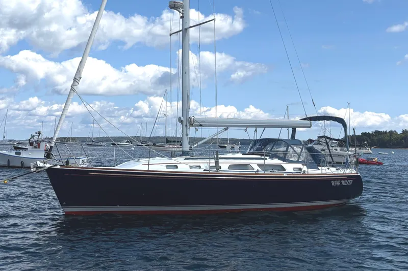 The Image of 2002 Sabre 402 sailboat on calm water under a clear blue sky. - 0