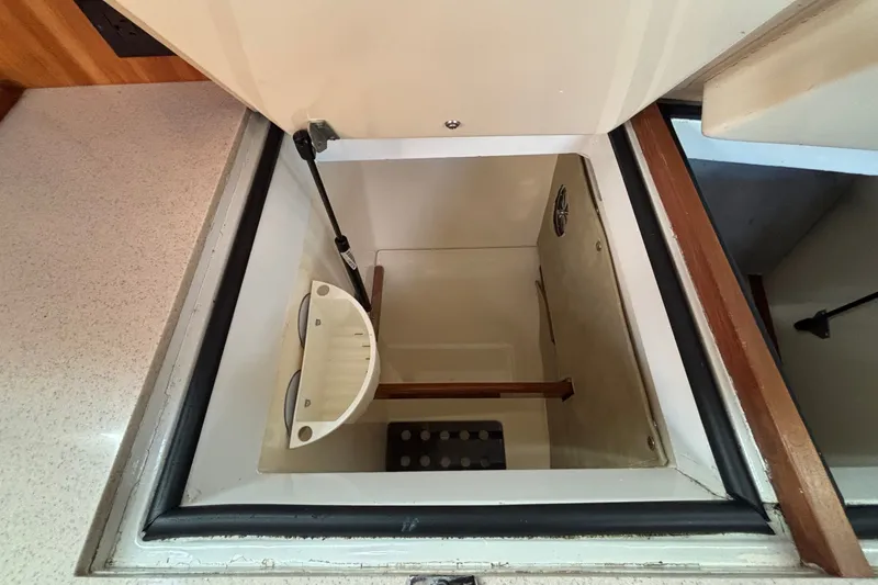 Slide: The Image of Storage compartment in a 2002 Sabre 402 yacht, featuring a built-in organizer. - 76