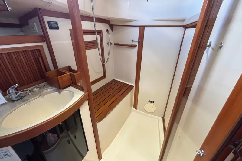 Slide: The Image of 2002 Sabre 402 yacht bathroom with wooden accents and modern fixtures. - 62