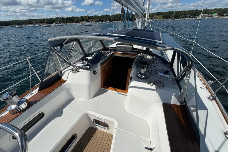 Slide: The Image of Sailing yacht Sabre 402, 2002 model, with spacious cockpit and scenic marina view. - 15