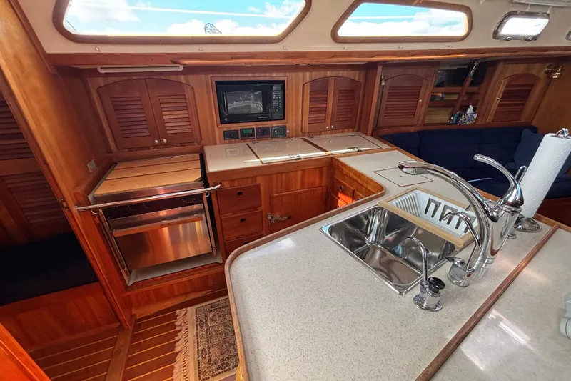 Slide: The Image of Luxurious 2002 Sabre 402 yacht interior with modern kitchen and wooden cabinetry. - 65
