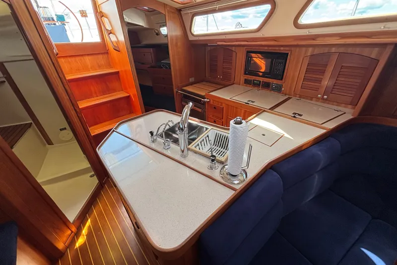 Slide: The Image of Luxurious interior of a 2002 Sabre 402 yacht featuring a modern kitchen and seating area. - 66