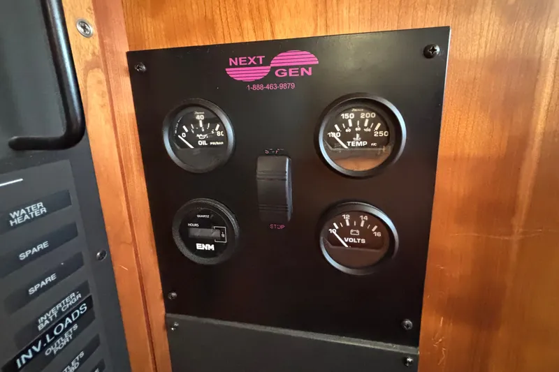 Slide: The Image of Control panel with gauges for oil, temperature, volts, and hours on a Sabre 402, 2002 model. - 47