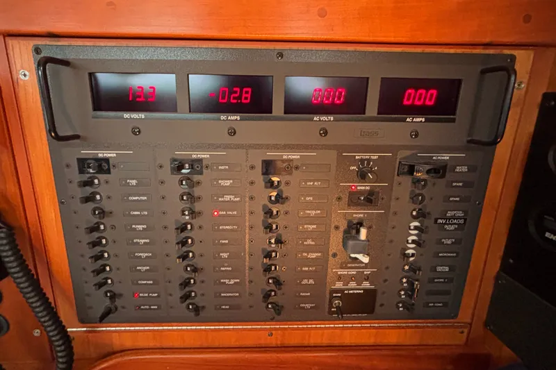 Slide: The Image of Electrical control panel of a 2002 Sabre 402 yacht, displaying voltage and amperage readings. - 37