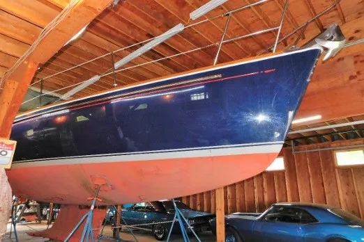 Slide: The Image of Sailboat Sabre 402 from 2002 in a wooden garage with classic cars. - 83
