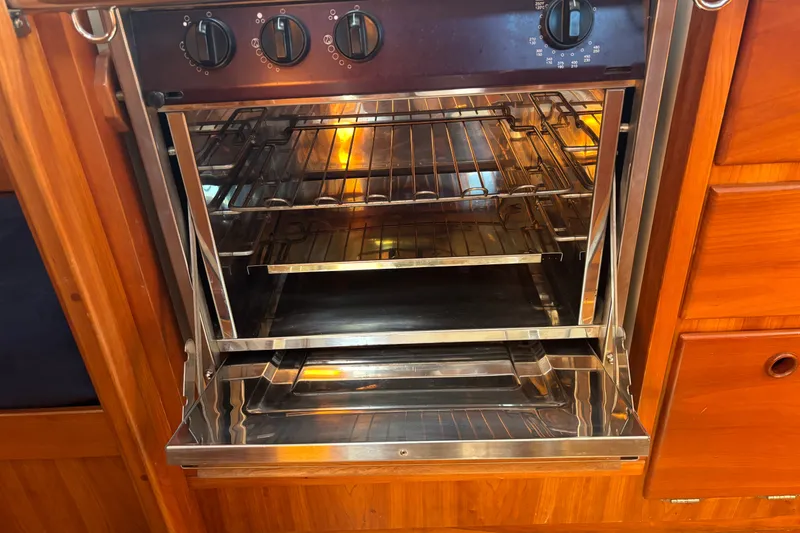 Slide: The Image of Open stainless steel oven in wooden kitchen, Sabre 402 model, 2002. - 68
