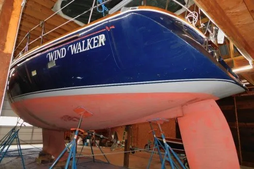 Slide: The Image of Blue Sabre 402 sailboat named "Wind Walker" in dry dock, 2002 model. - 84