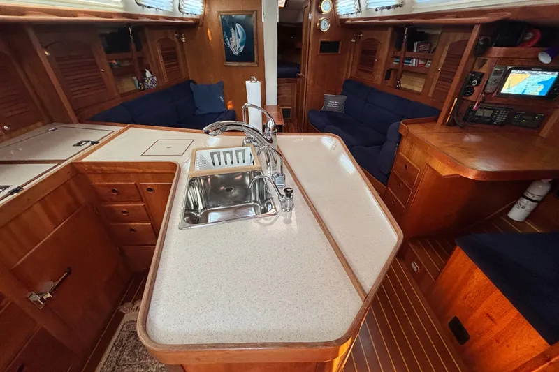 Slide: The Image of Luxurious interior of a 2002 Sabre 402 yacht featuring a modern kitchen and cozy seating area. - 72