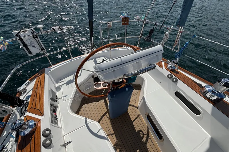 Slide: The Image of Cockpit of 2002 Sabre 402 sailboat with wooden accents and steering wheel. - 18