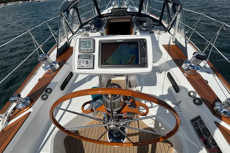 Slide: The Image of Cockpit of 2002 Sabre 402 sailboat with navigation equipment and wooden steering wheel. - 19