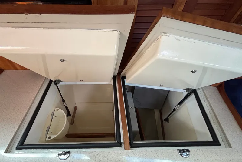 Slide: The Image of Open storage compartments on a 2002 Sabre 402 boat, showcasing interior space and design. - 74