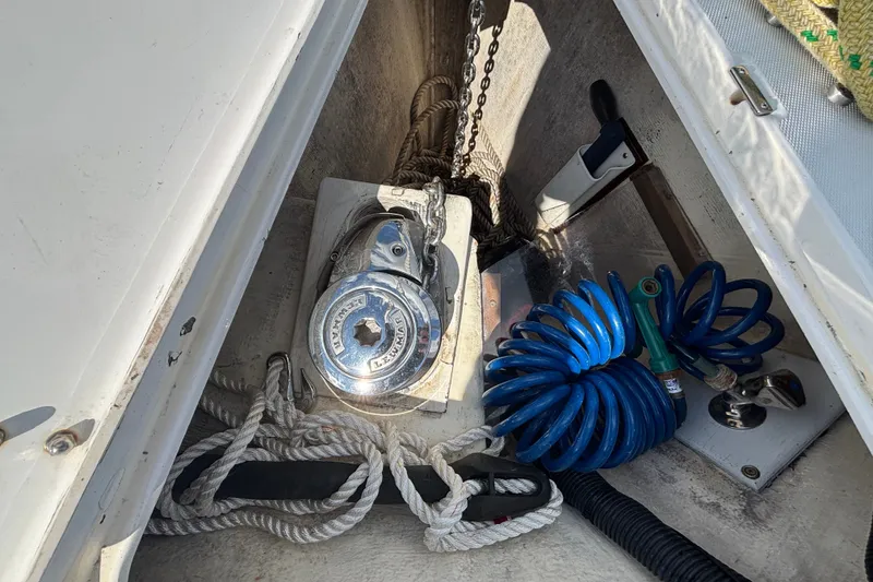 Slide: The Image of Anchor locker of 2002 Sabre 402 sailboat with ropes and coiled hose. - 32